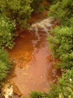 Un râu poluat de o mină de cupru abandonată din Anglesey, Țara Galilor.